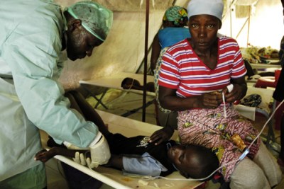 A young cholera victim receives treatment (file photo).