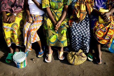 Women sit together outside their dormitory at the Heal Africa Transit Center for women victims of sexual violence.