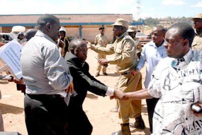 Kizza Besigye, left, was attacked during a protest.