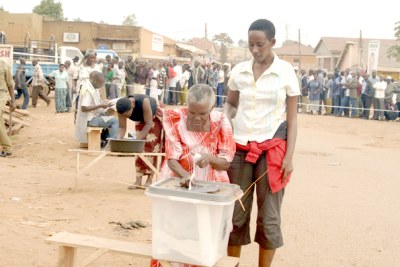 An elderly lady is helped to vote at Namuwongo Katale voting centre. This center started voting at 9am.