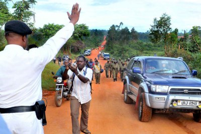 A traffic officer stops a car on it's way to Kampala (file photo).