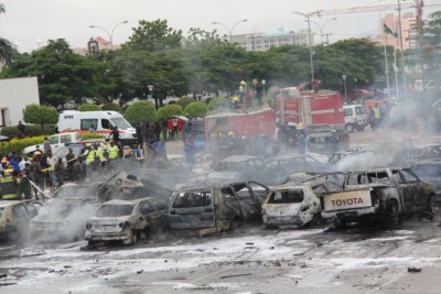 Fire fighters at the scene of the bomb blast at the Car Park, Police Force Headquarters, Abuja (file photo).