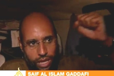 Muammar al-Gaddafi's son Saif al-Islam, who had reportedly been arrested by opposition fighters, has appeared in the streets of Tripoli.