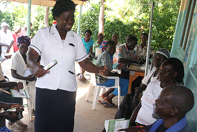Kenyan Nurse, Pamela Achieng Sombe talks to patients at Nduru Kadero dispensary.