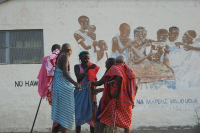 Maasai youth and elders gather early one morning before a meeting about reproductive health begins.