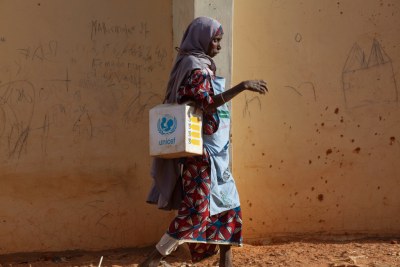 A local health worker carries polio vaccines in Nigeria (file photo).