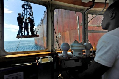 Crew members leave a tanker in the anchorage. (file photo)