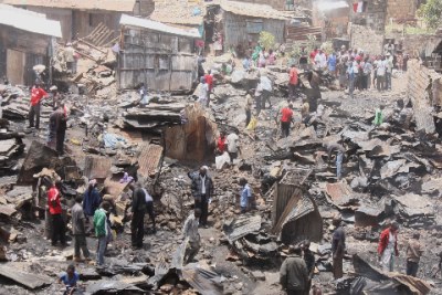Residents of Mathare 10 area salvage property after an overnight fire: The cause of the fire is still unknown but there are reports that an illegal electricity connection is to blame.