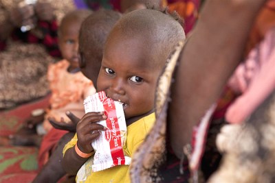 A malnourished boy eats UNICEF-provided therapeutic food.
