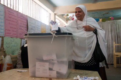 A woman casts her ballot at a Cairo polling station.