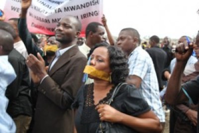 Some journalists from various media houses who took part in a peaceful demonstration to condemn the killing of their colleague, TV journalist Daudi Mwangosi, wave banners at the Jangwani Grounds in Dar es Salaam.