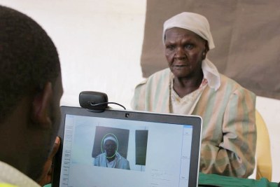 A voter is registered using the Biometric Voter Registration kit in Korogocho (file photo).