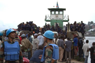 Government police arrive at Goma as UN peacekeepers watch in December 2012 after the M23 withdrew from the town in eastern DRC. The UN changed its mandate from peacekeeping force to an intervention force starting early May 2014.