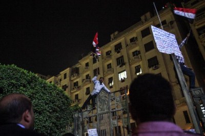 An anti-government protester waves Egyptian flag outside the high court (file photo).