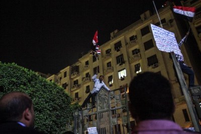 An anti-government protester waves the Egyptian flag outside the High Court.