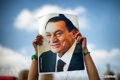 A supporter holds a poster of Egyptian former President Hosni Mubarak during a demonstration in Cairo, Egypt