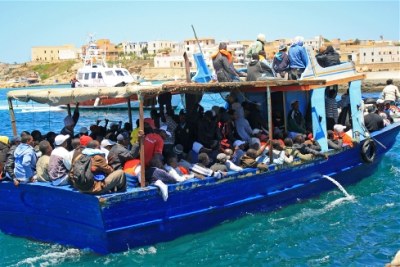 A boat carrying migrants arrives at the Lampedusa port, escorted by the coastguard (file photo).