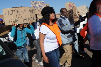 Protesters demonstrate during a march to the home affairs department against revised immigration regulations in Johannesburg on Wednesday, 25 June 2014.
