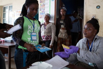 Health workers distribute brochures on Ebola in Freetown.
