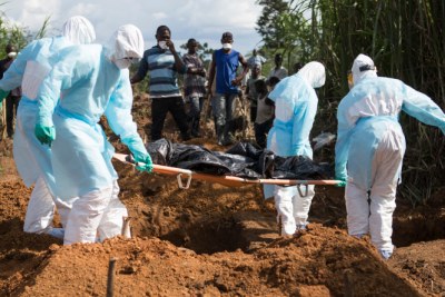 Burying Ebola victims in Sierra Leone.