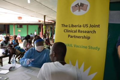 Liberian registered pharmacists, in protective gear, transfer the Ebola test vaccines from vials to syringes, for transport from a holding facility to Redemption Hospital in Monrovia for the Ebola vaccine study.