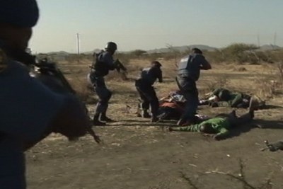 Police inspecting the bodies of strikers who had been killed (file photo).