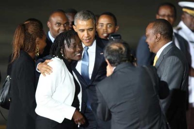 President Obama hugs his half-sister, Dr Auma Obama, upon his arrival at Jomo Kenyatta International Airport in Nairobi.