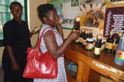 The Ministry of Trade and Industry public relations officer, Ms Khadijja Nakakande, inspects products in Yumbe Town.
