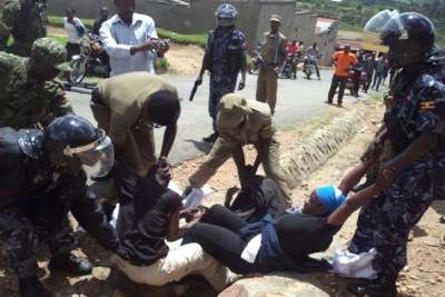 Police officers arrest opposition protesters in Bushenyi during the Free-my-vote activities.