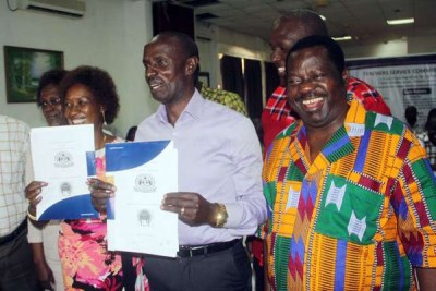 Teachers Service Commission chief Nancy Macharia and Kenya National Union of Teachers secretary-general Wilson Sossion exchange copies of the CBA that they signed on June 21, 2016 at the Mombasa beach hotel. In the background is TSC chairperson Lydia Nzomo and on the left is KNUT chairman Mudzo Nzili.