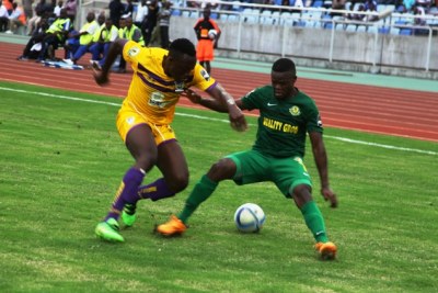 Young Africans striker Obrey Chirwa battles for the ball with Ghana's Medeama player Salufu Moro
