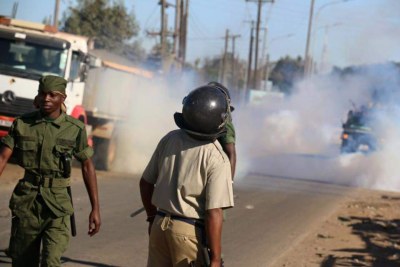 Police firing teargas teargas canisters to disperse opposition UPND leader Hakainde Hichilema's supporters in Monze.