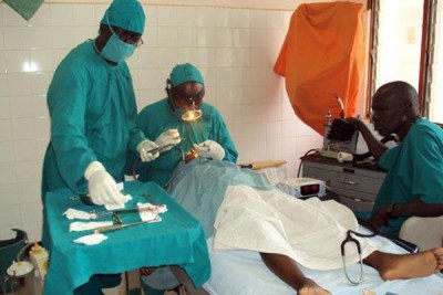 Surgeons attend to a patient in the theatre.