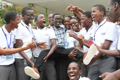 Jubilant Feza Boys students in Dar es Salaam carry high the best overall candidate in the 2016 National Form Four Examinations, Alfred Shauri, soon after the results were announced.