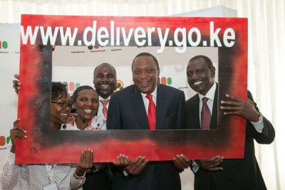 President Uhuru Kenyatta and Deputy President William Ruto pose with government officers at the launch of the National Government Public Information Portal at KICC in Nairobi on April 10, 2017.