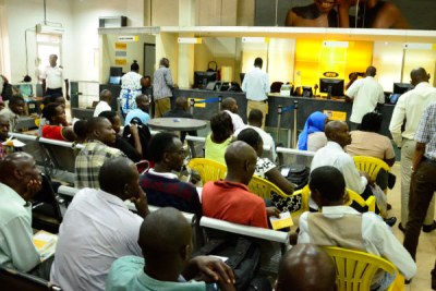 People wait to register their SIM cards at an MTN service centre in Kampala recently.