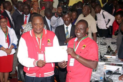 Jubilee party Presidential candidate Uhuru Kenyatta and his running mate William Ruto show their certificate at Kenyatta International Convention Centre on May 29, 2017 after they were cleared by the Independent Electoral and Boundaries Commission.