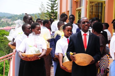 Principal and founder of St Lawrence Schools and Colleges Lawrence Mukiibi (right) during a thanksgiving service at one of the schools (file photo).
