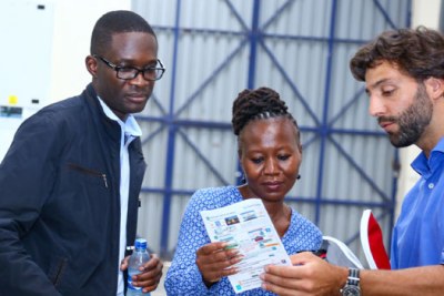 Independent Electoral and Boundaries Commission CEO, Ezra Chiloba (left) flanked by IEBC Commissioner, Roselyn Akobe (Centre) and Safran Identity & Security Executive Jean Copin (right) reviewing a Kenya Integrated Elections Management System training tool at the firm’s Nairobi Warehouse.