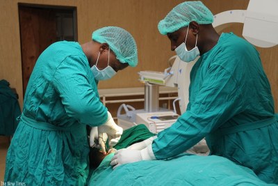 Doctors at Rwanda Military Hospital, Kanombe, perform an operation.