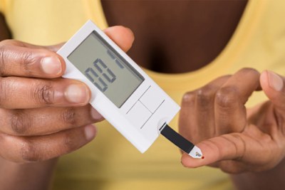 A woman testing for blood sugar level.