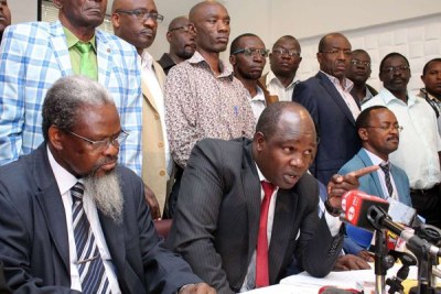 Universities Academic Staff Union (Uasu) chairman Mugo Kolale (left), Secretary-General Constantine Wasonga and other union members during a press conference at Meridian Hotel in Nairobi.