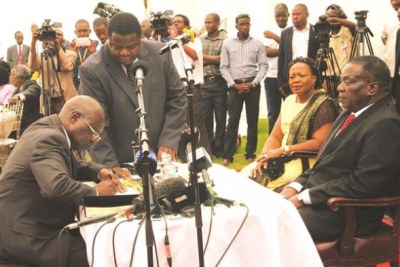 President Emmerson Mnangagwa swears in Advocate Ray Hemington Goba as substantive Prosecutor-General, while flanked by First Lady Auxillia Mnangagwa in December 2017. (file photo).