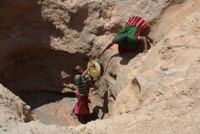 Women fetch water from a well (file photo).