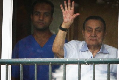 Former Egyptian leader Hosni Mubarak waves at his supporters from a window at Maadi Military hospital on Egypt's national day in 2015.