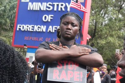 A Liberian anti-rape protester outside President George Weah's office at the ministry of foreign affairs in downtown Monrovia.