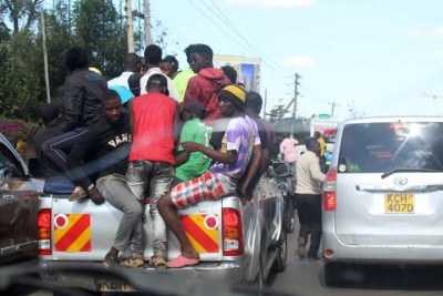 Youths ride on an overloaded pick-up truck along James Gichuru Road in Nairobi on October 4 in blatant violation of traffic and Covid-19 rules.