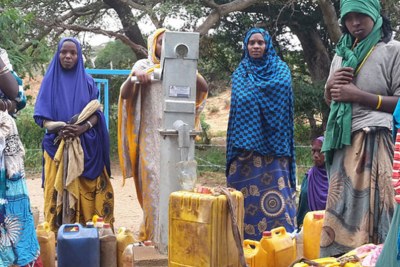 Women fill their containers at a water collection point in the Oromia region of Ethiopia (file photo).