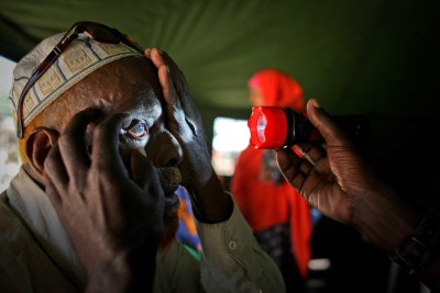 A health worker providing free medical services to members of displaced populations.