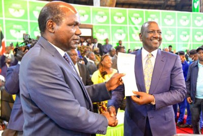 Independent Electoral and Boundaries Commission (IEBC) Chairperson Wafula Chebukati hands Deputy President William Ruto the certificate of election as President-Elect.